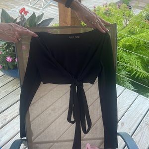 Black top with strings that tie and pink longsleeve top